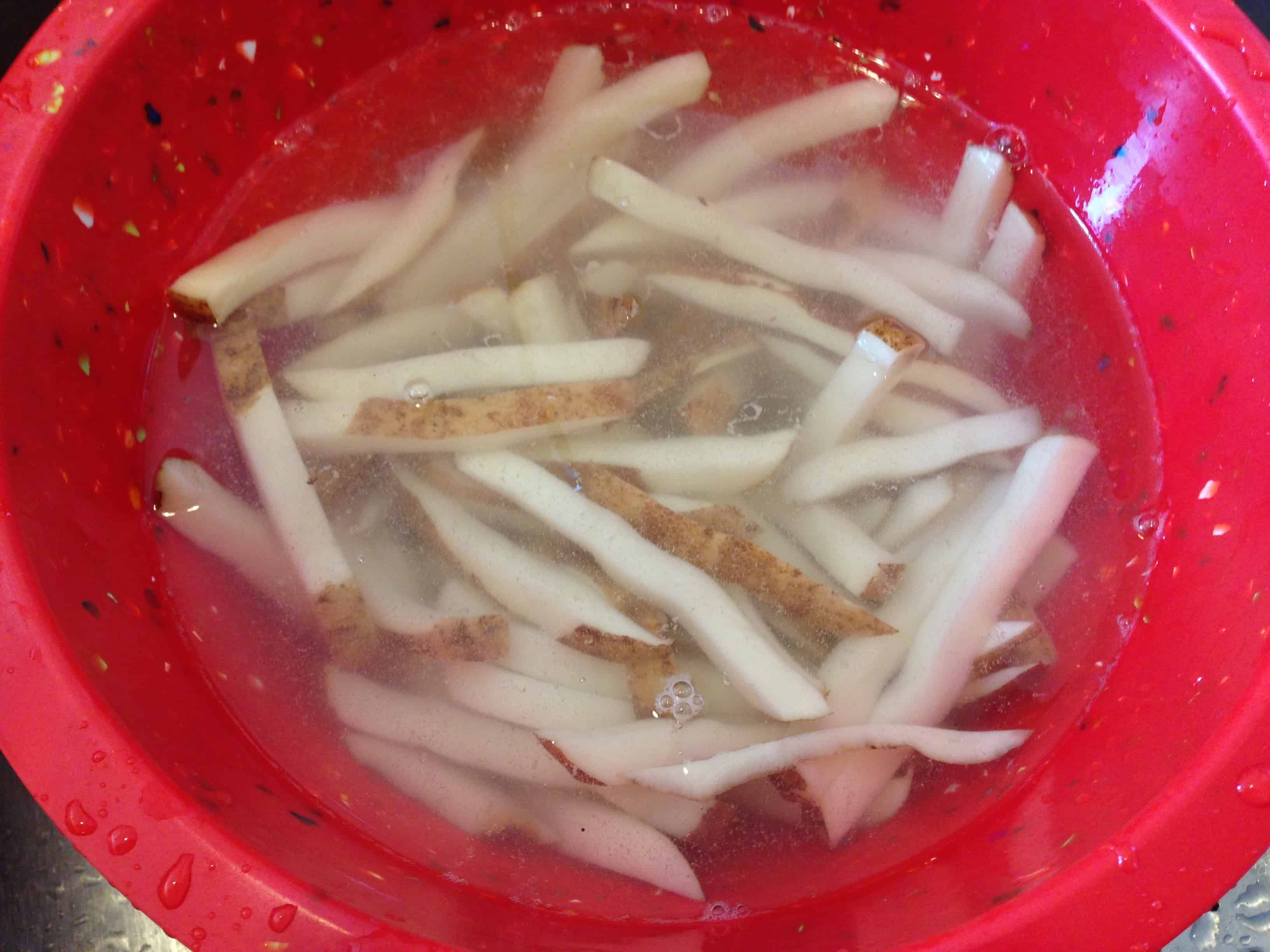 The fries soaking in water to remove starch