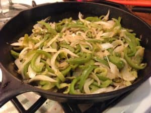 Peppers and onions in a cast iron pan