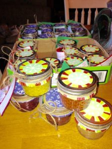 Homemade gifts: small jars of jam and mustard decorated for giving