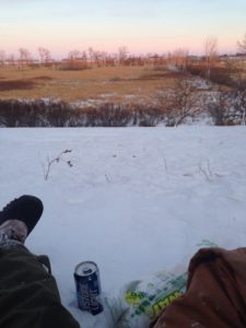 Having a picnic with my husband while we watch the sunset in a snowy field
