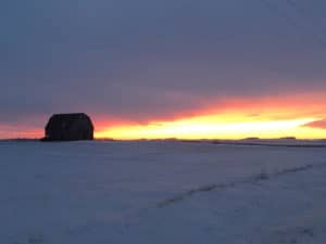 Beautiful winter sunset in Minnesota near an abandoned barn