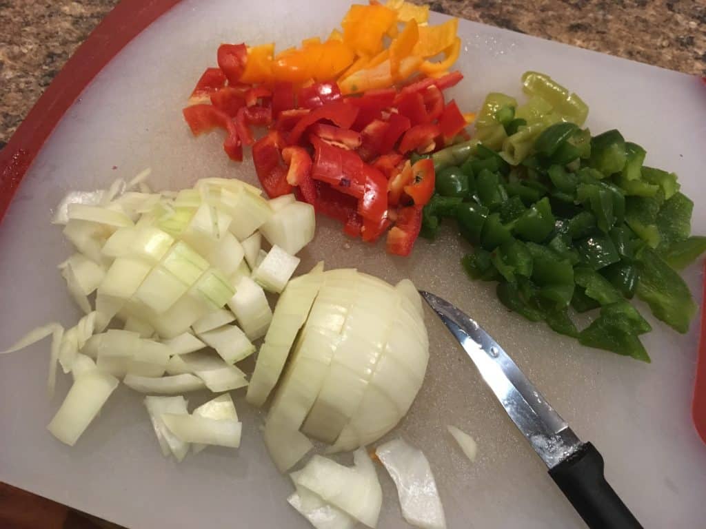 Chopping the onions and peppers for Loaded Potato Nachos