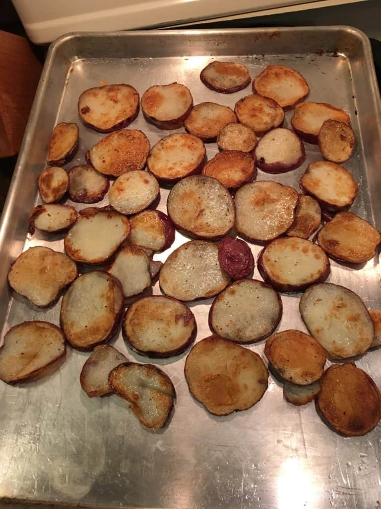 The fried potato slices arranged on baking sheet for Loaded Potato Nacho prep