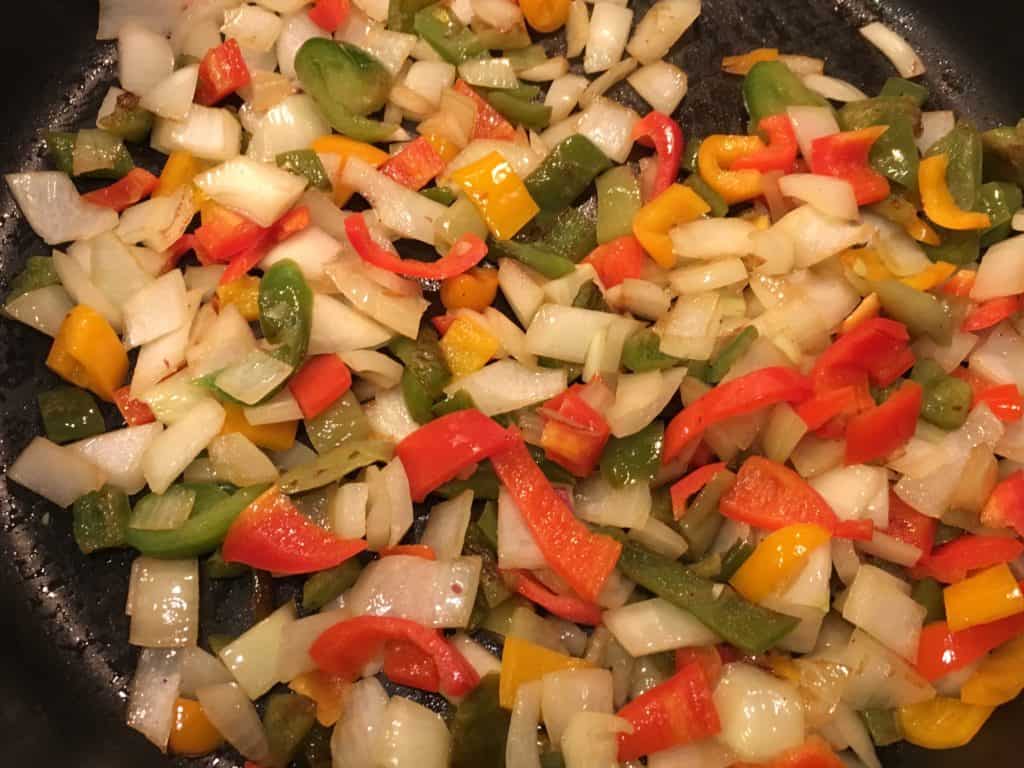 Sauteeing the peppers and onions for Loaded Potato Nachos