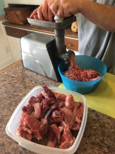 Processing the turkey meat with pork in our grinder to make sausage