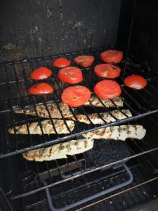 The fish and tomatoes on the smoker