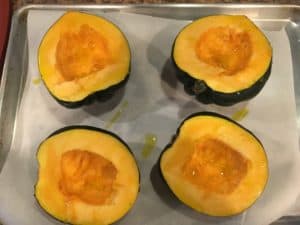 Acorn squash with seeds removed, before baking