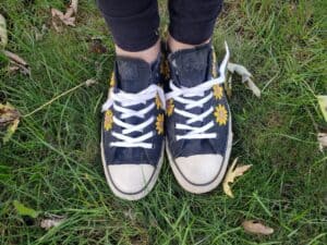 Black Converse sneakers with yellow sunflowers