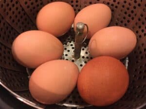 Fresh eggs in a steamer basket