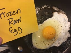 Frozen raw egg in saucepan