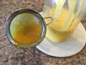 The lemon zest in the sieve after the lemon curd straining process