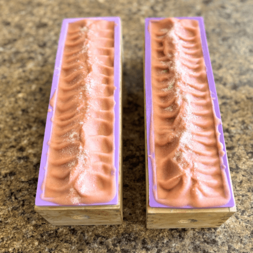 Process photo showing two loaves of freshly poured Salty Sunrise goat's milk soap