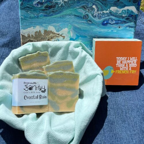 Exterior photo of coastal rain soap on a sunny day with a few beach-themed props