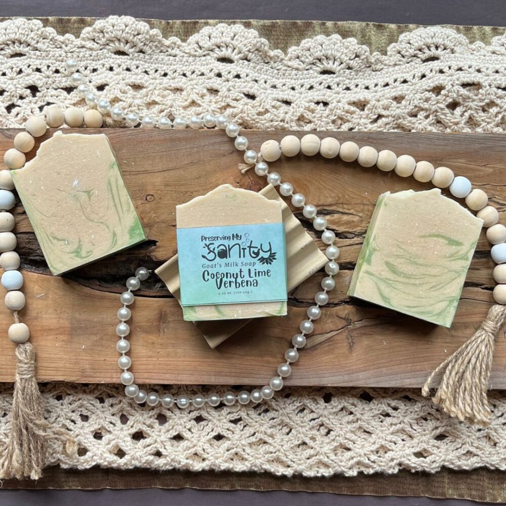 Pretty interior flatlay of coconut lime verbena soap surrounded by crochet, wooden beads, and pearls.