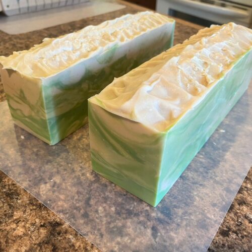 Interior photo showing two loaves of coconut lime verbena soap after taking it out of the mold before cutting into bars