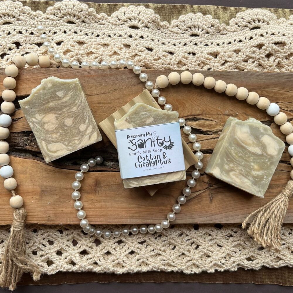 Pretty interior flatlay of cotton and eucalyptus soap with a backdrop of crochet, wooden beads, and pearls