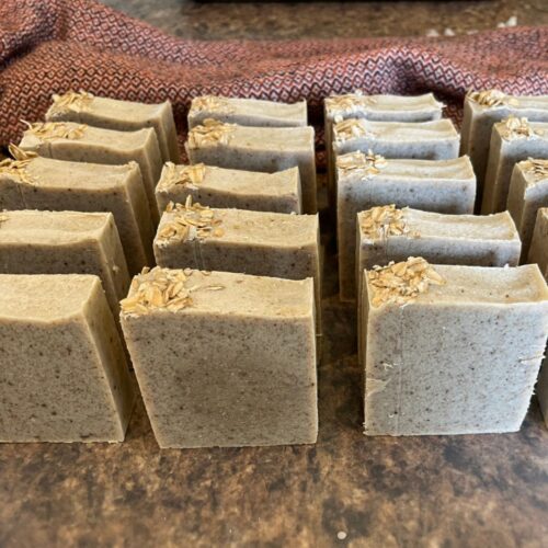 Interior photo of rows of pretty bars of oatmeal chamomile soap taken just after cutting before going on the curing rack.