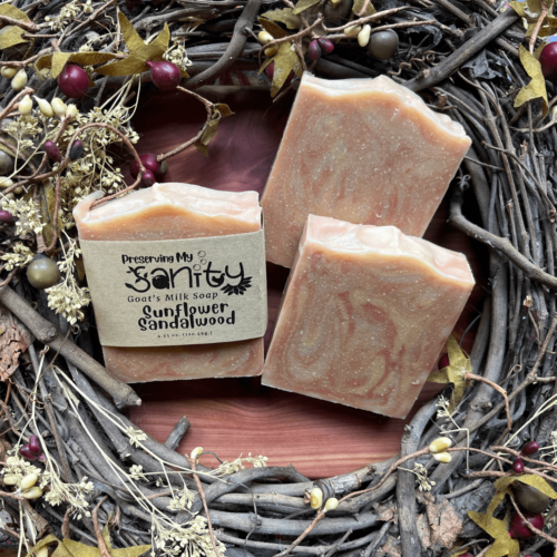 Three bars of sunflower sandalwood soap with a fall flatlay of a pretty grapevine wreath.