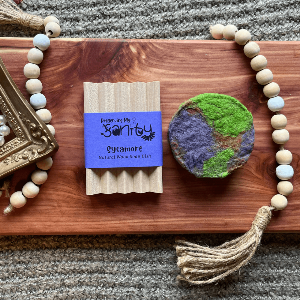 Flatlay photo showing a colorful felted Nag Champa bar and a wooden soap dish to be given as a stocking stuffer bundle