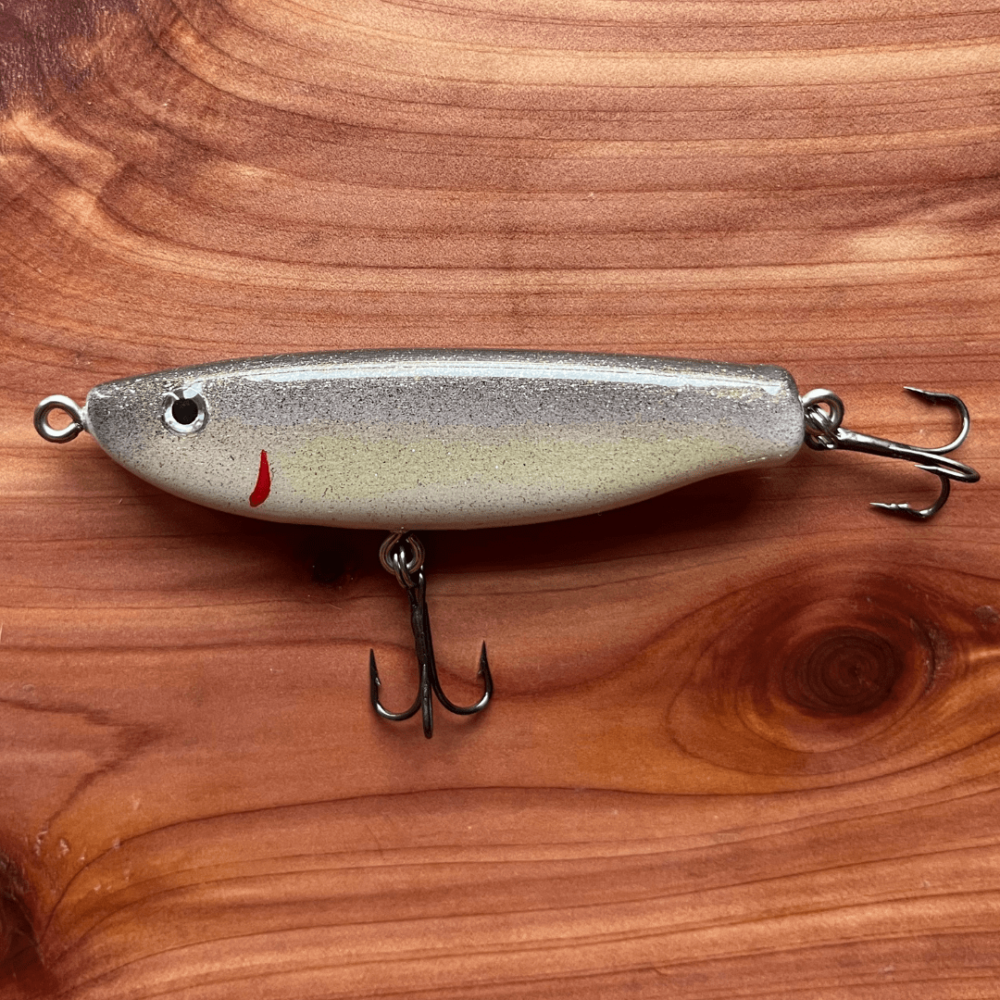 Flatlay photo of a handmade Marshall's Minnows fishing lure in Black Shad color