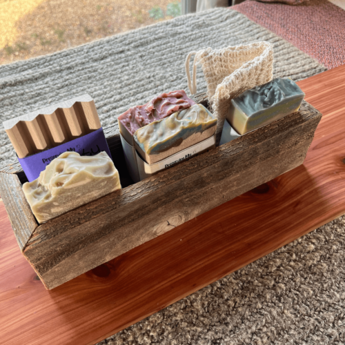 Medium sized reclaimed wood box displayed with four bars of goat milk soap, a wooden soap dish, and a sisal soap saver bag