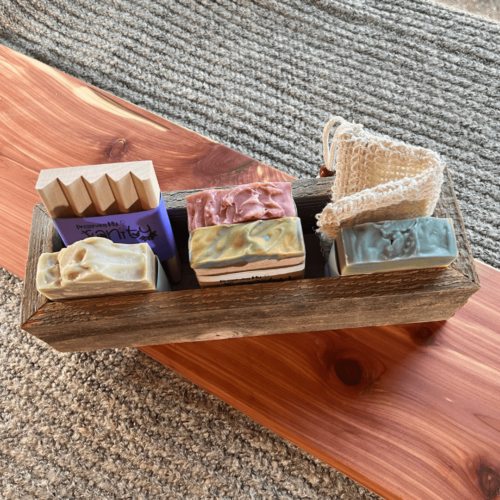 Flatlay photo of medium sized reclaimed trough for building your own gift bundle. Picutred with four bars of soap, a wood soap dish, and a sisal soap saver bag (not included)