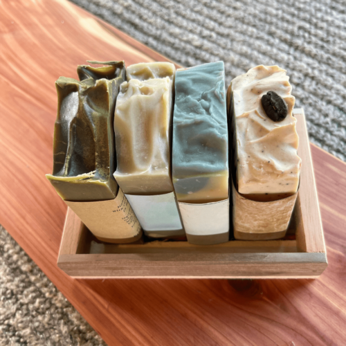 Reclaimed wood tray for creating your own gift set, pictured with four bars of handcrafted goat's milk soap inside (not included) sitting on a cedar board