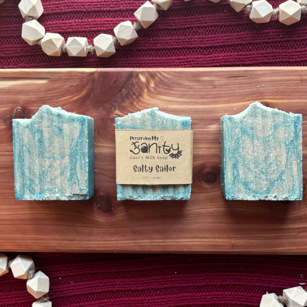 Flatlay photo of three bars of Salty Sailor sea salt goat's milk soap