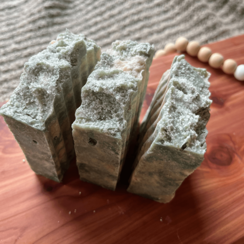 Side and top view of three bars of Salty Sailor sea salt goat's milk soap