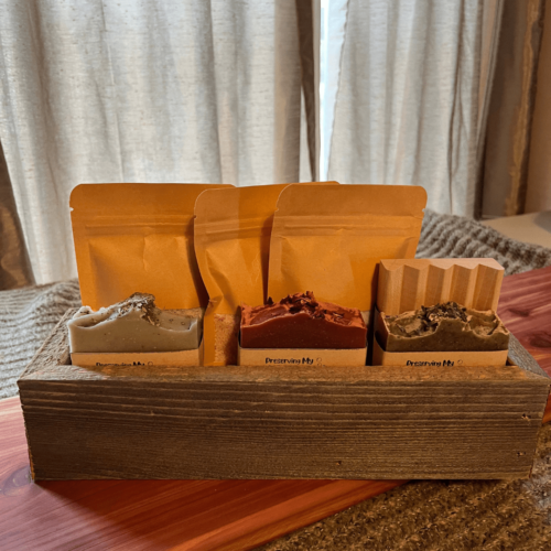 Another alternate view of the soap and salt bundle that includes a reclaimed wood trough, three bags of bath salt, three bars of handcrafted goat's milk soap, and a wood soap dish