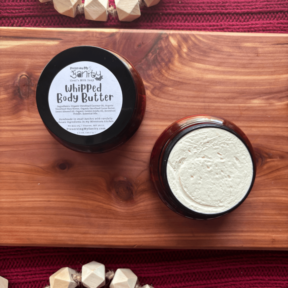 Flatlay photo of whipped body butter in a 4-ounce brown jar