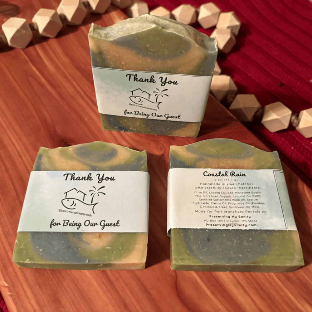 Flatlay photo showcasing three 2-ounce bars of Coastal Rain soap that was created for a custom vacation rental order.