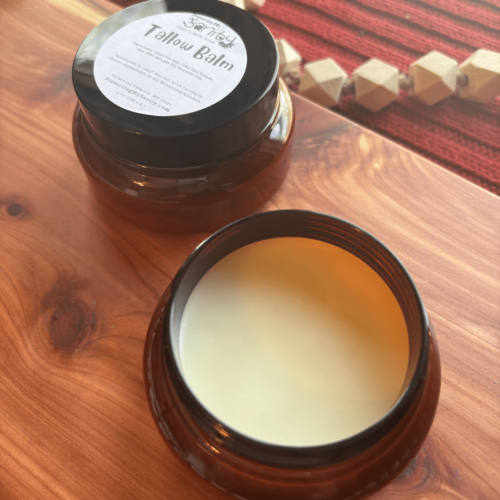 Flatlay photo of tallow balm in a 4-ounce container