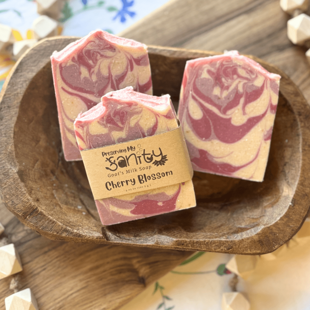 Flatlay of three bars of Cherry Blossom goat's milk soap
