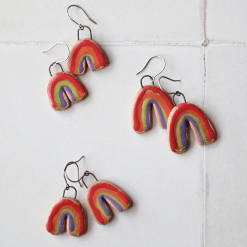 Flatlay photo showing three pairs of ceramic rainbow earrings