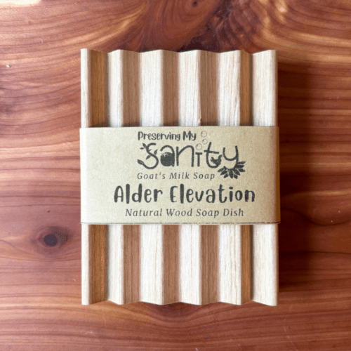 Simple flatlay photo showing an alder elevation-style natural wood soap dish made in the USA