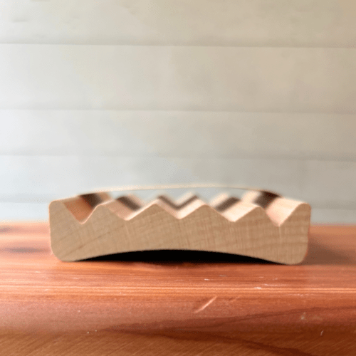 Alternate side view photo showing an alder elevation-style natural wood soap dish made in the USA