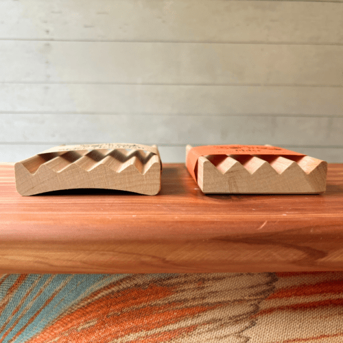 Alternate side view photo showing a regular alder natural wood soap dish beside an elevation-style alder natural wood soap dish - both made in the USA