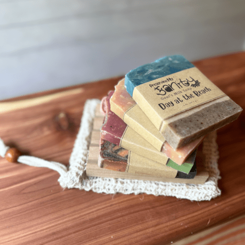 Alternate view of summer soap sampler featuring four half-size bars of soap, a sisal soap saver bag, and a natural wood soap dish.