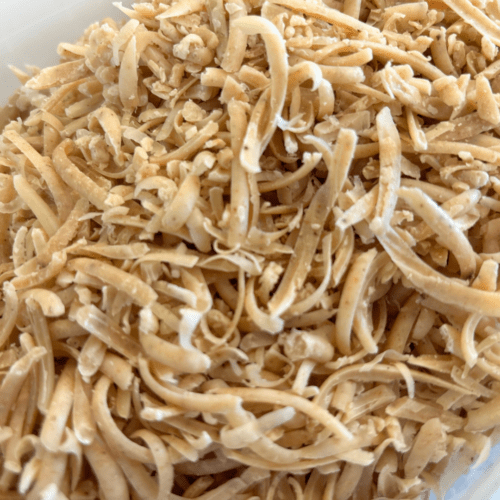 Photo showing goat milk soap bath sprinkles in a container before getting bagged up for sale