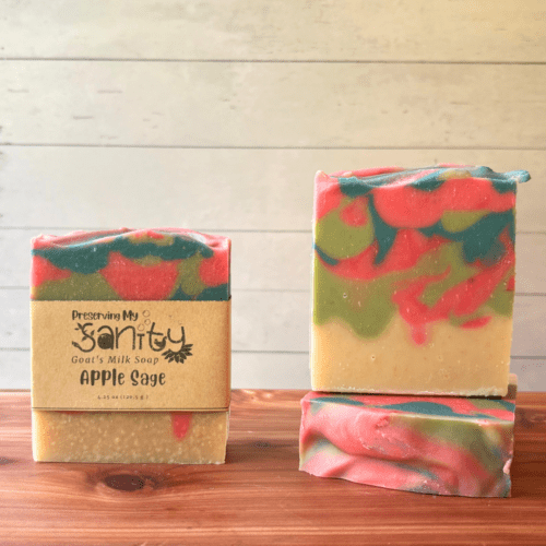 Display photo showcasing three bars of Apple Sage goat milk soap, with a fun drop swirl pattern featuring bright pink, green, and aqua blue. This is a bestselling fall scent that sold out twice last year!