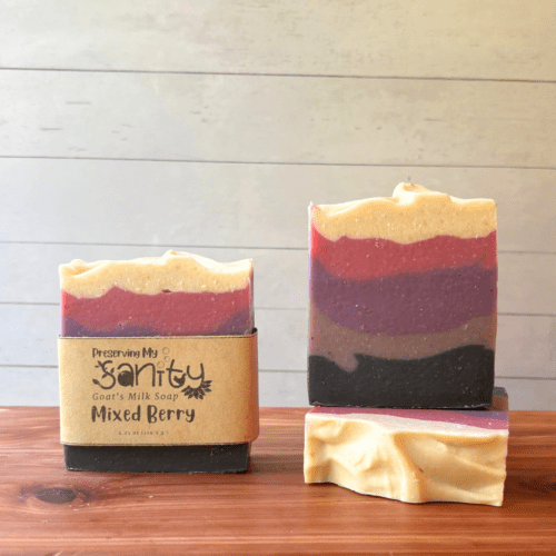 Display photo showcasing three bars of five-color stripe Mixed Berry soap. Handcrafted in small batches using Minnesota goat milk.