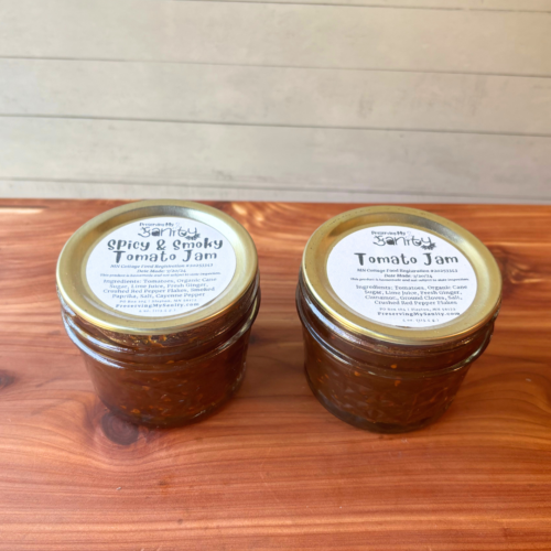 Partial side and top view of two jars of tomato jam, made with my homegrown Minnesota tomatoes. Jam available includes Spicy and Smoky Tomato Jam and regular Tomato Jam. Shipping is not available, only local pickup.