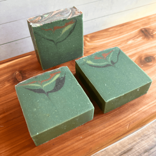 Alternatei view display photo showcasing three bars of Forest Berries goat milk soap, part of the holiday collection