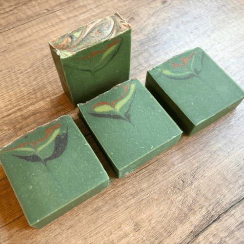 Alternatei view display photo showcasing four bars of Forest Berries goat milk soap, part of the holiday collection