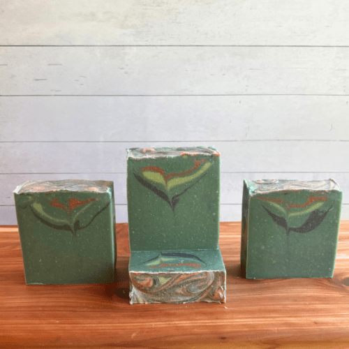 Display photo showcasing four bars of Forest Berries goat milk soap, part of the holiday collection