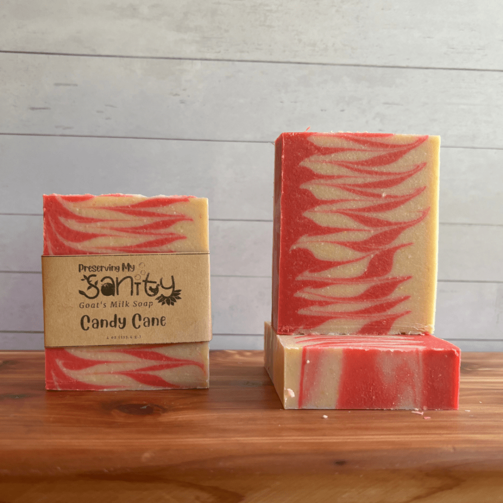 Photo of three bars of Candy Cane goat milk soap arranged to show different angles and parts of handcrafted soap bars