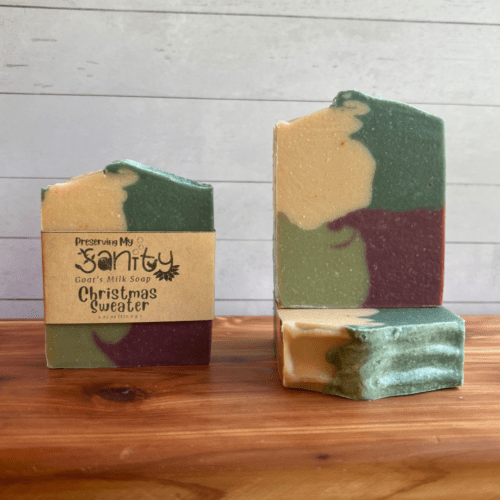 Photo of three bars of Christmas Sweater goat milk soap arranged to show different angles and parts of handcrafted soap bars