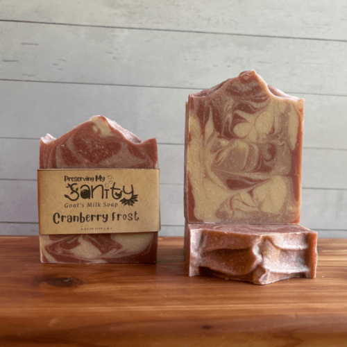 Photo of three bars of Cranberry Frost goat milk soap arranged to show different angles and parts of handcrafted soap bars