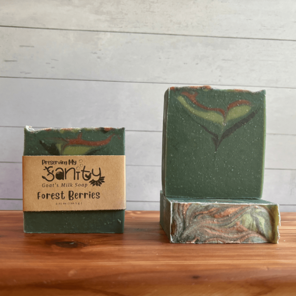 Photo of three bars of Forest Berries goat milk soap arranged to show different angles and parts of handcrafted soap bars